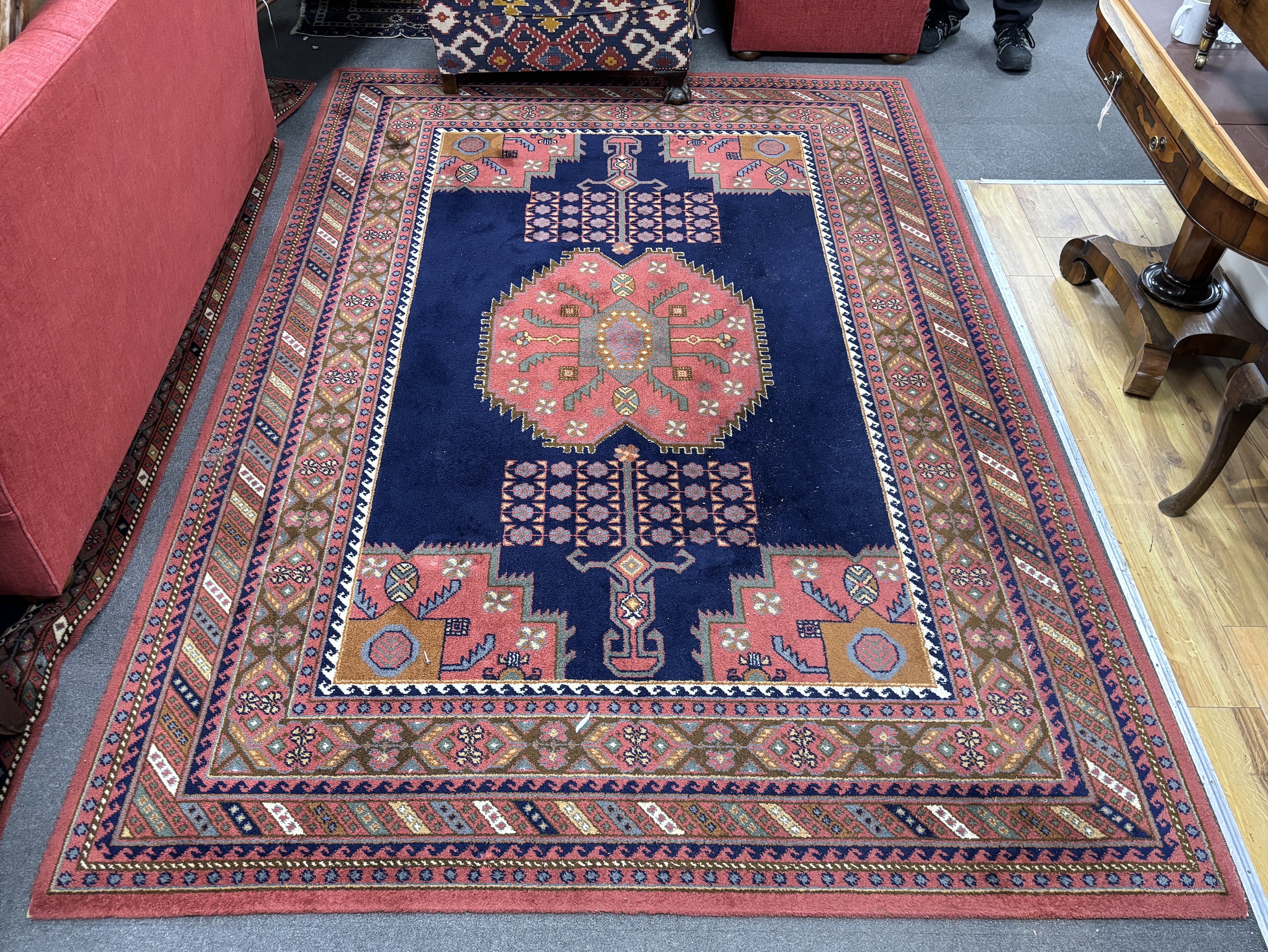 A North West Persian style machined blue ground carpet together with a similar runner, larger 295 x 190cm